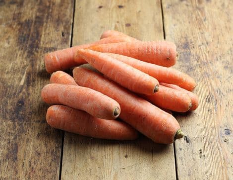 Colorful rainbow carrot sticks in orange, purple, and yellow
